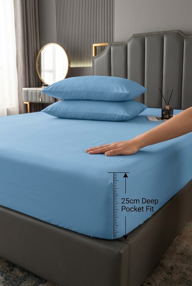 Blue deep-pocket fitted sheet on a made bed